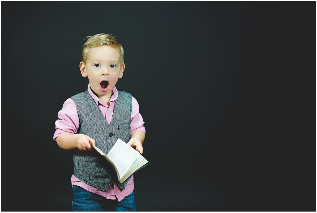 Child holding book practicing phonetic awareness activities