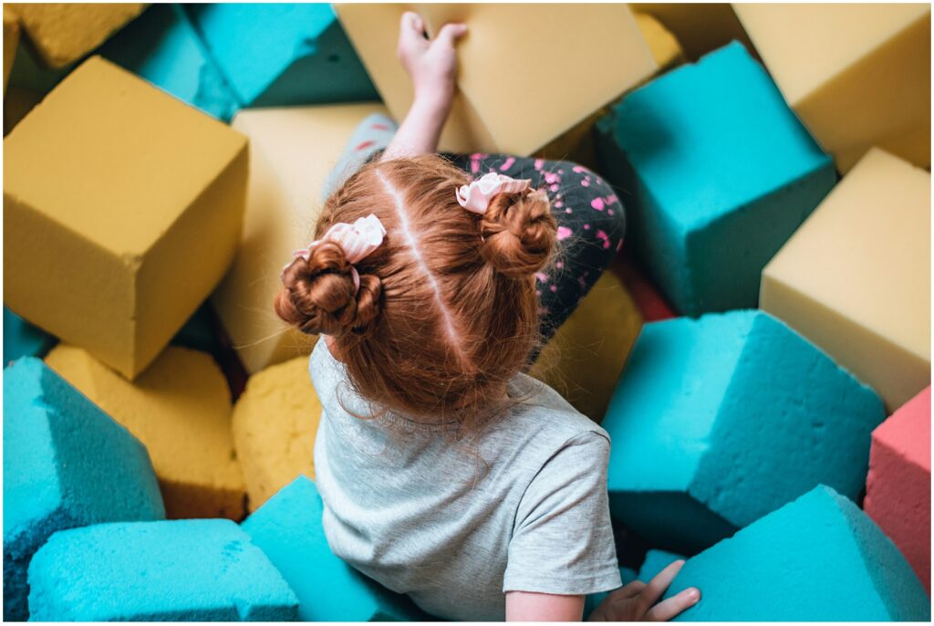 Toddler playing with foam blocks whose parents are wondering when to worry about speech delay