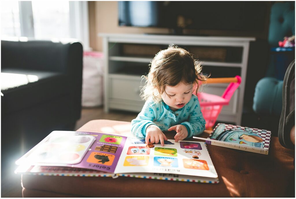 Toddler with the Einstein speech delay looking at a book