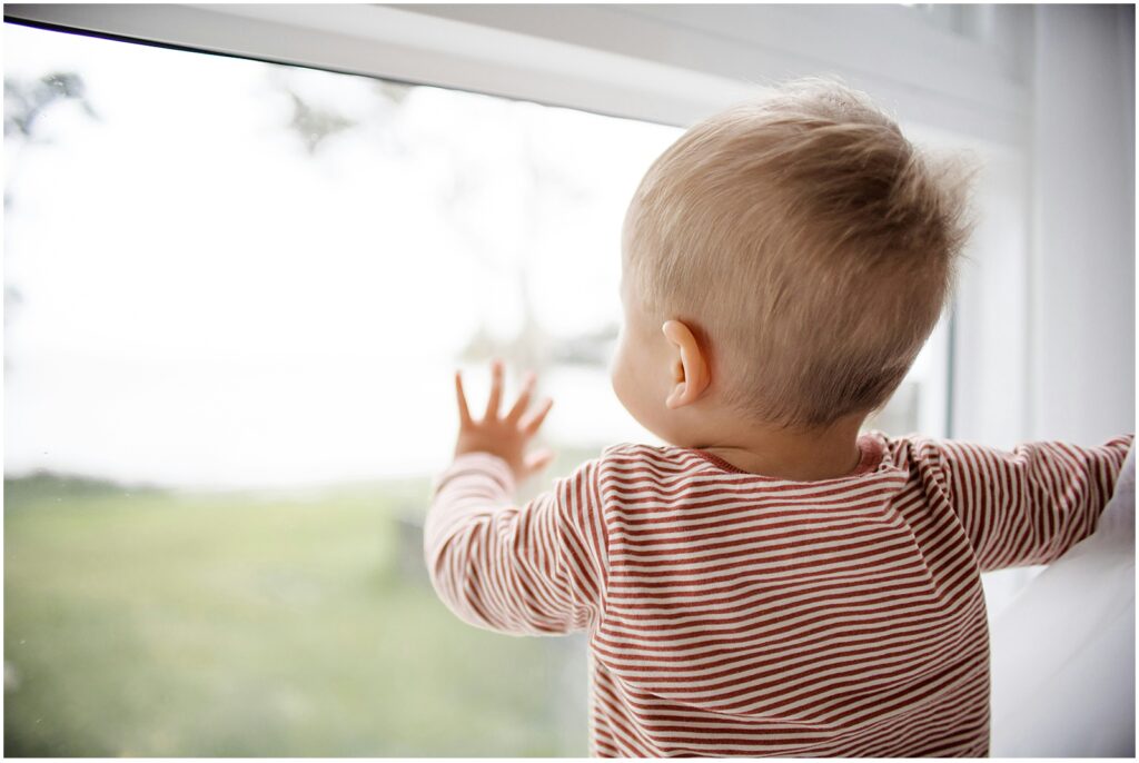 Toddler looking out window representing what is joint attention